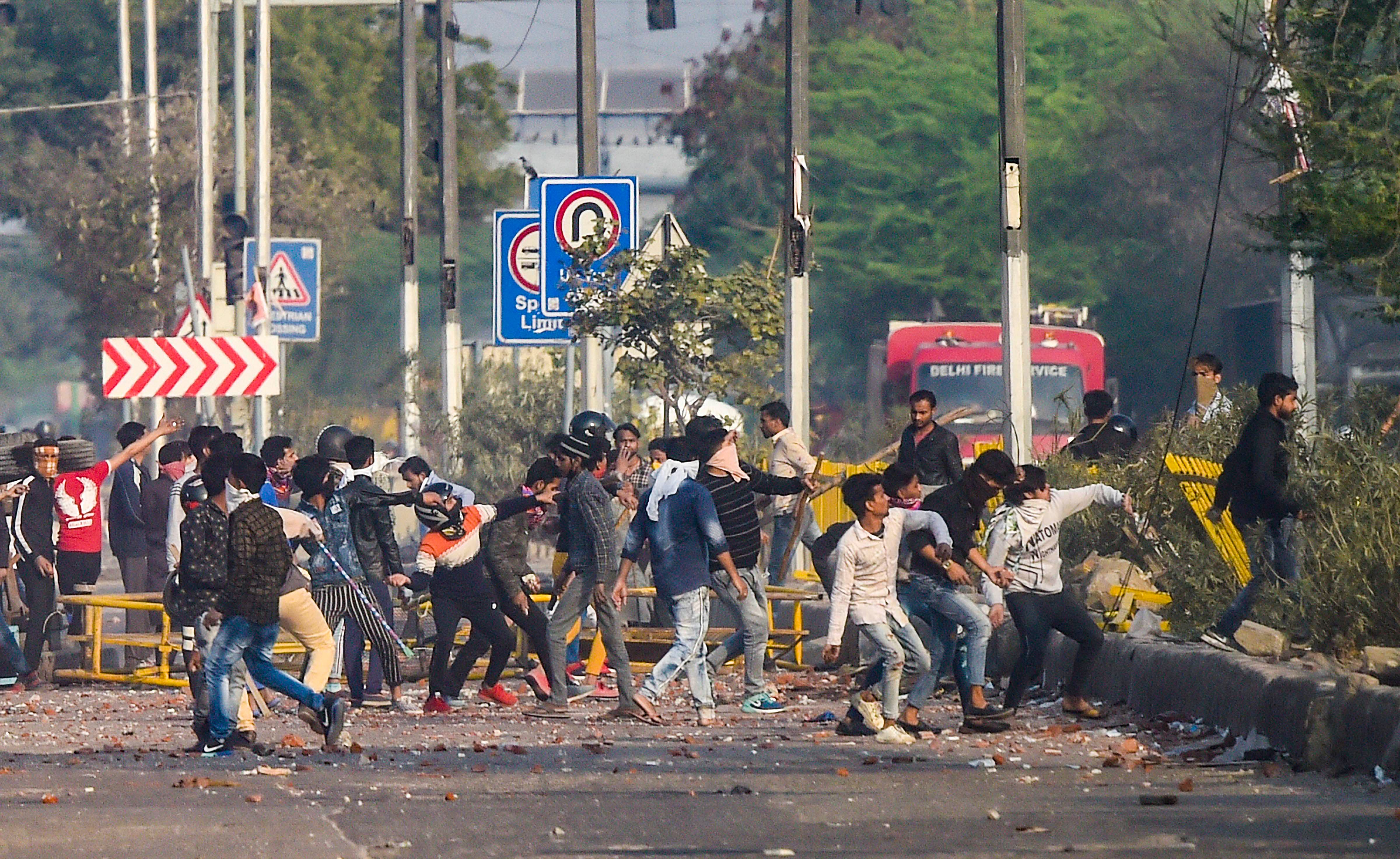 Rioters pelt stones during clashes between those against and those supporting the Citizenship (Amendment) Act in north east Delhi, Tuesday, Feb. 25, 2020. The violence that started on Monday spread to many parts of north east Delhi, leading to death of nine people and injuries to many including police personnel. (PTI Photo)