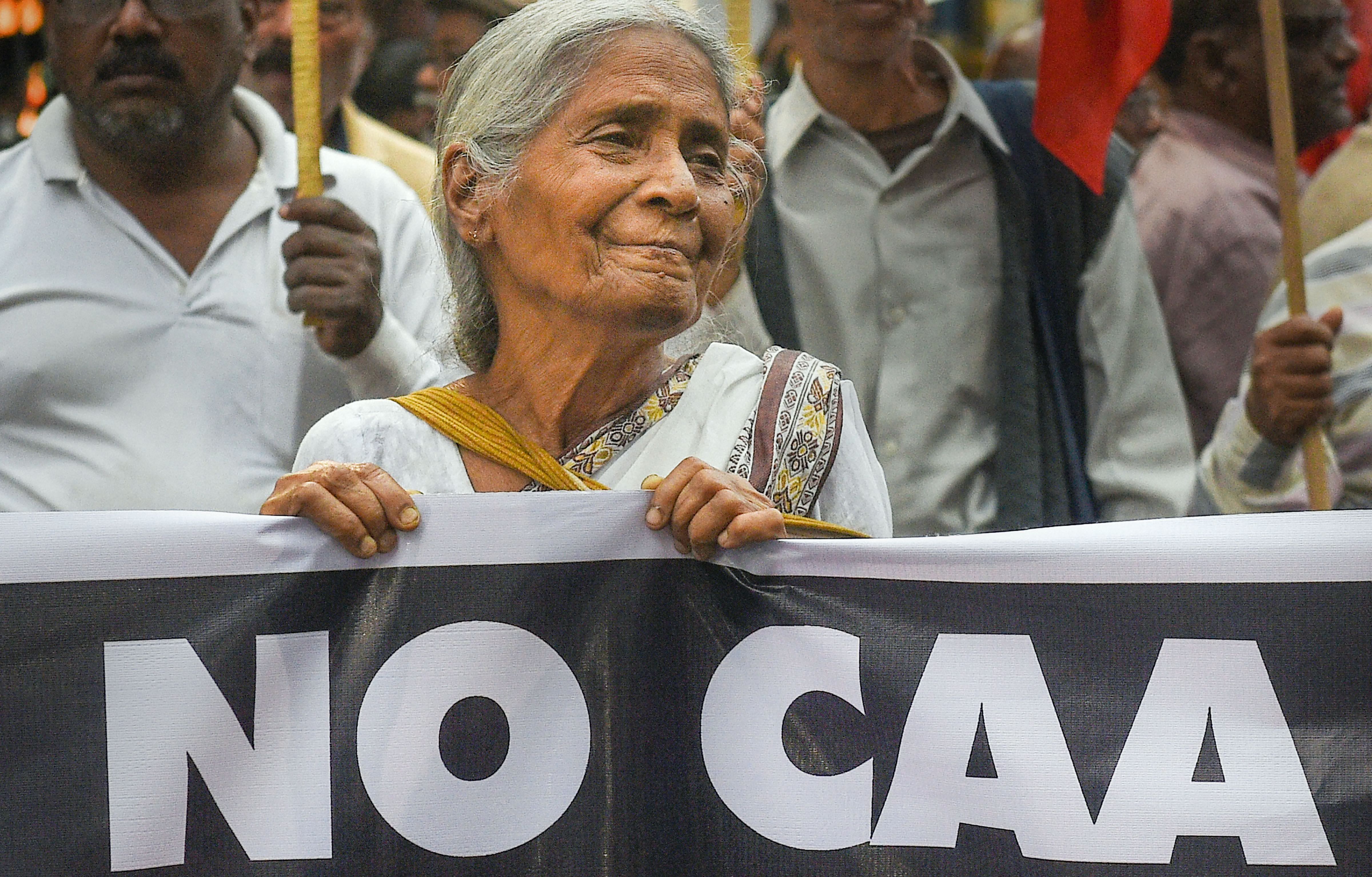 An elderly woman participates in a protest against NRC, CAA and violence in east Delhi area, in Kolkata, Wednesday, Feb. 26, 2020. (PTI Photo)
