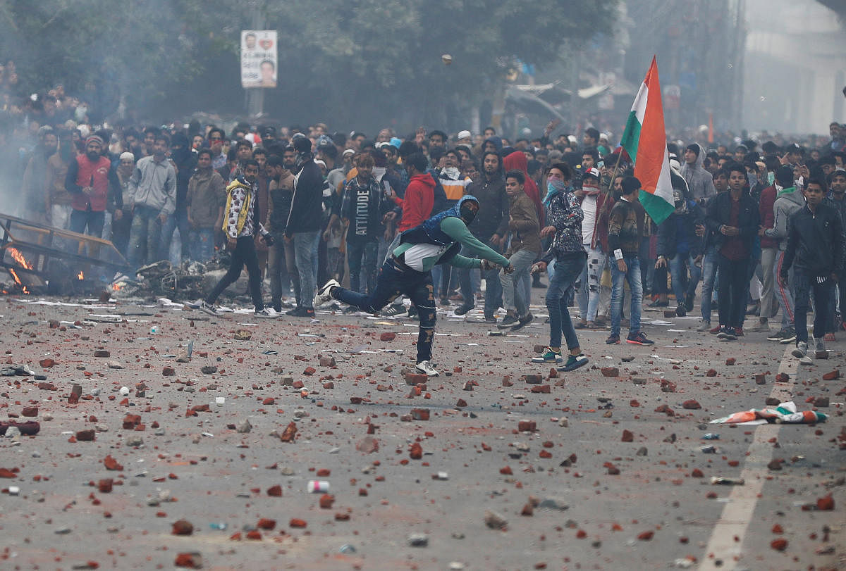 Demonstrators throw stones towards police during a protest against a new citizenship law in Delhi. (Representative Image/REUTERS Photo)