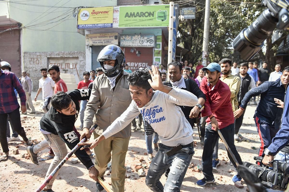  Protestors during clashes between a group of anti-CAA protestors and supporters of the new citizenship act, at Jafrabad in north-east Delhi, Monday, Feb. 24, 2020. (PTI Photo)