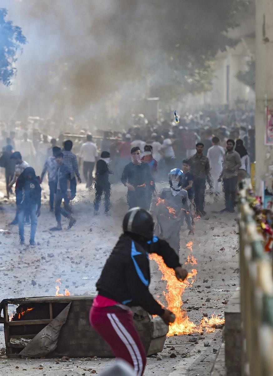  A protestor hurls a petrol bomb during clashes between a group of anti-CAA protestors and supporters of the new citizenship act, at Jafrabad in north-east Delhi, Monday, Feb. 24, 2020. (PTI Photo)