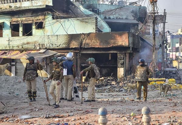 Security personnel stand guard near a neighbourhood vandalised by rioters during clashes between those against and those supporting the Citizenship (Amendment) Act in north east Delhi, Tuesday, Feb. 25, 2020. (PTI Photo)