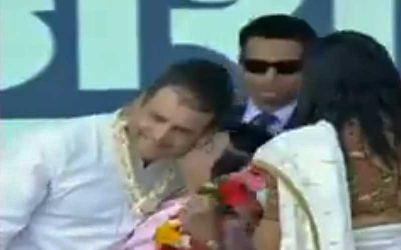A screenshot from video, which shows Rahul is kissed by a woman worker.