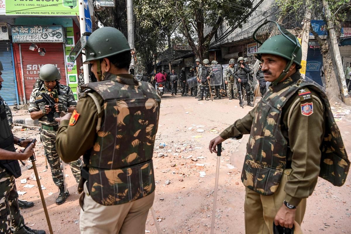 Security personnel stand guard on a street following clashes between people supporting and opposing a contentious amendment to India's citizenship law in New Delhi on February 26, 2020. (AFP Photo)