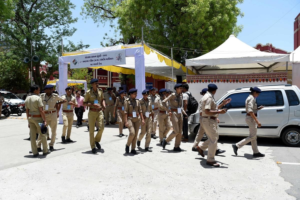 Gujarat state police officials walk in the premises at a counting centre on the eve of vote counting day of India's general election in Ahmedabad. The Election Commission has rejected the charge by opposition parties that attempts were being made to manip