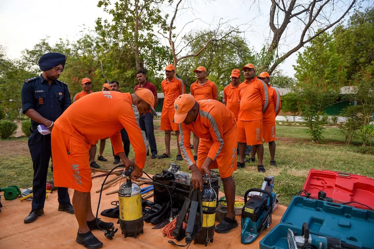 Personnel from India's 6th National Disaster Response Force (NDRF) check emergency and rescue material at an NDRF camp in Chiloda (also called Naroda), some 40 kms from Ahmedabad on June 11, 2019. (Photo: AFP)