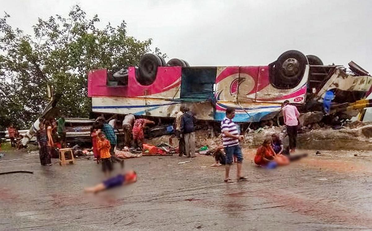  A bus, carrying devotees from Banaskantha's Ambaji Temple, turns turtle after colliding with a truck, near Trishulia Ghat in Banaskantha. (PTI Photo)