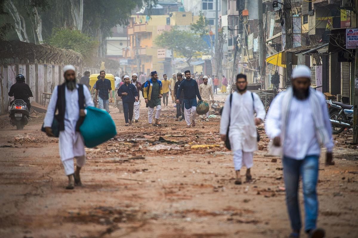People leave their houses following clashes over the new citizenship law, in Shiv Vihar area of northeast Delhi, Thursday, Feb. 27, 2020. Credit: PTI Photo