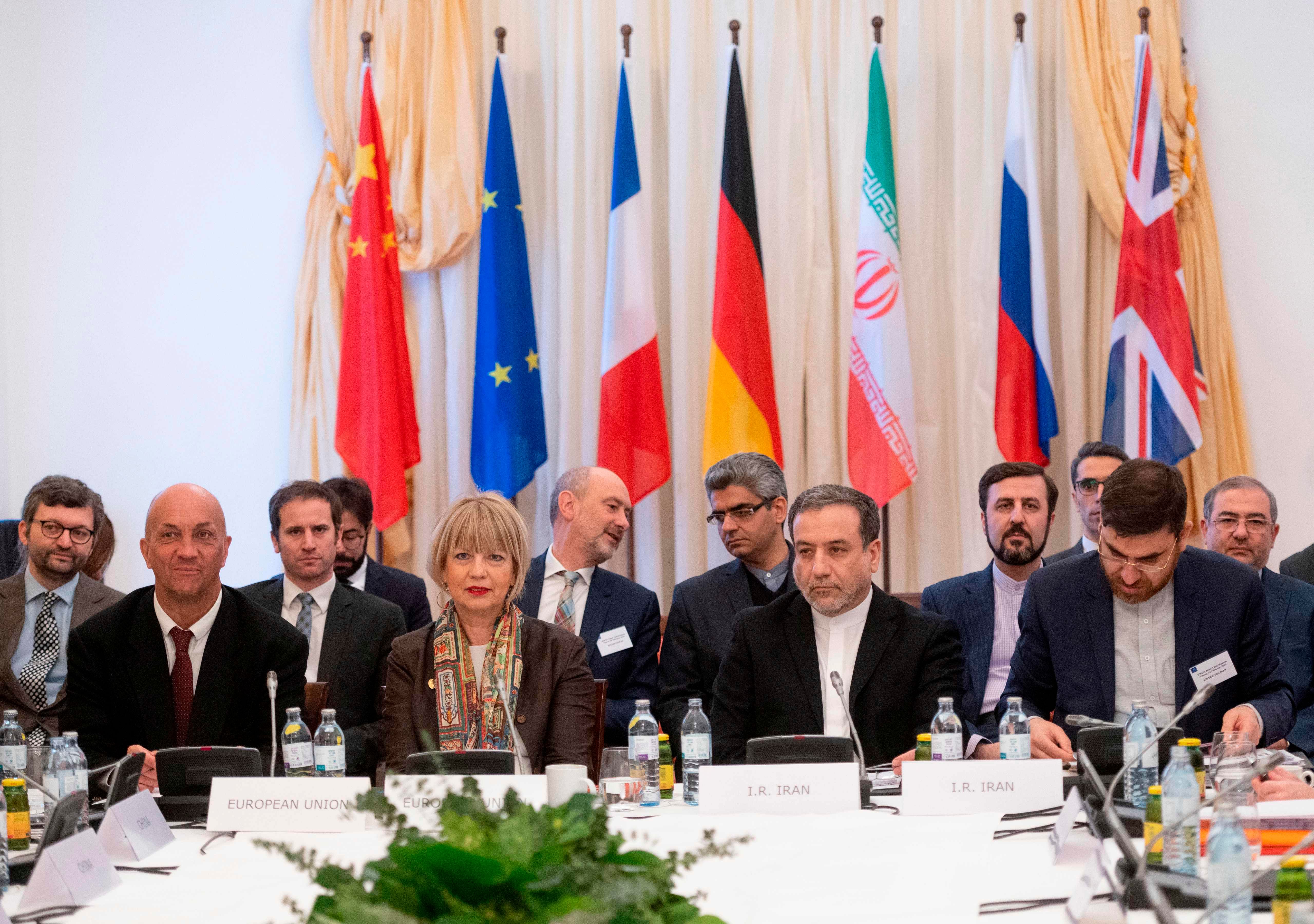 Abbas Araghchi (C-R), political deputy at the Ministry of Foreign Affairs of Iran, and the Secretary General of the European Union External Action Service (EEAS) Helga Schmid (C-L) attend a Meeting of the JCPOA Joint Commission on Iran's nuclear program at the EU Delegation. (Credit: AFP Photo)