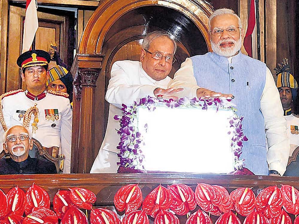 President Pranab Mukherjee and Prime Minister Narendra Modi press buttons to launch Goods and Services Tax at midnight in the Central Hall of Parliament in New Delhi on Saturday. PTI