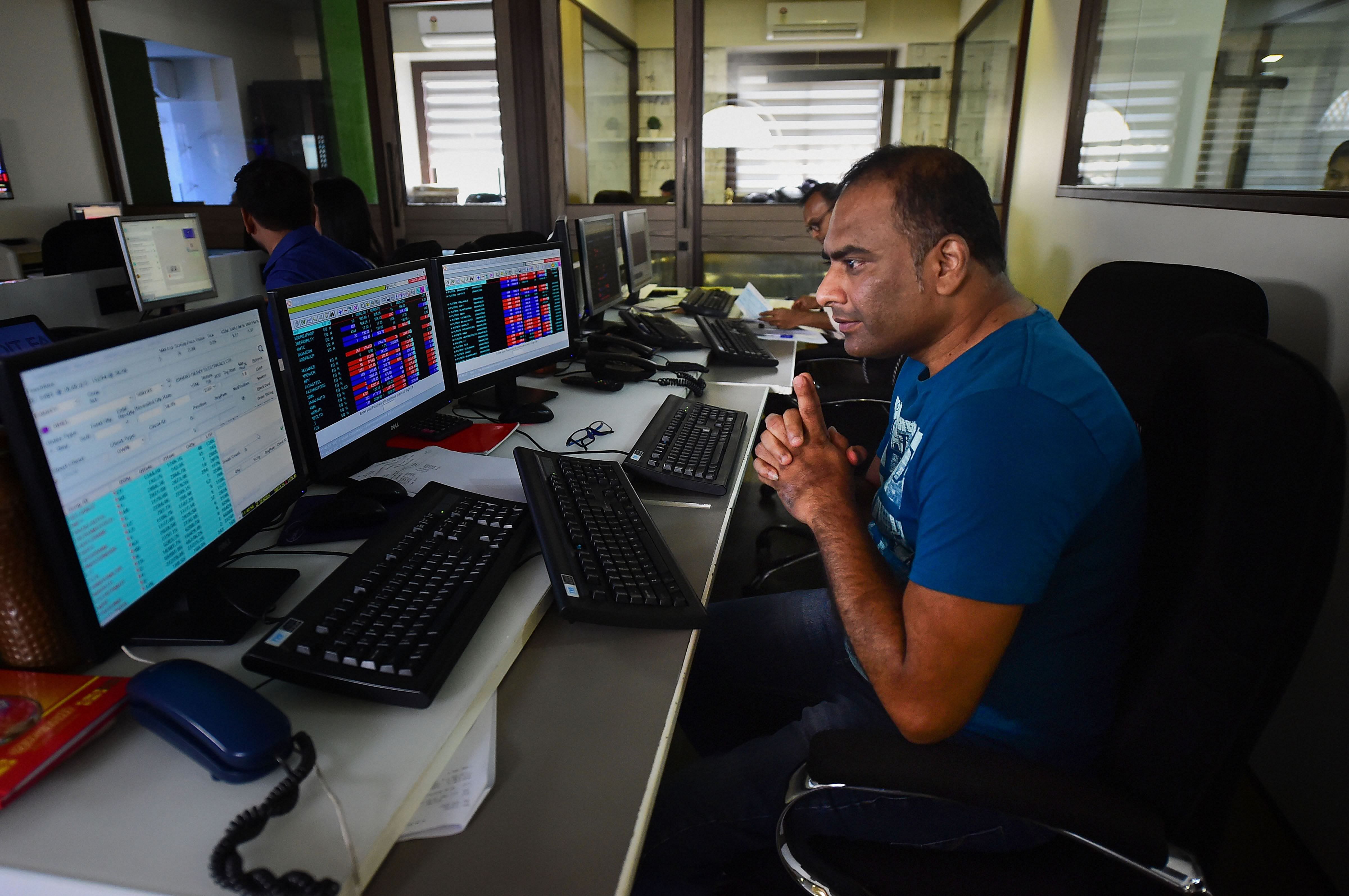 Traders monitor BSE index at a brokerage firm, as the Sensex goes down, in Mumbai. (PTI Photo)