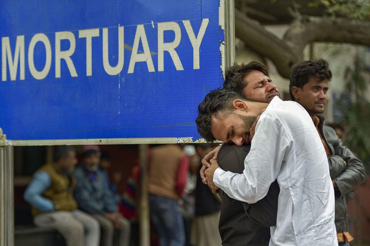 Kins of Mohsin Ali, who died in communal violence over the new citizenship law in northeast Delhi, cry after receiving his dead body outside the mortuary of GTB Hospital, in New Delhi, Thursday, Feb. 27, 2020. The death toll in the communal violence has reached 32 till today. (PTI Photo)