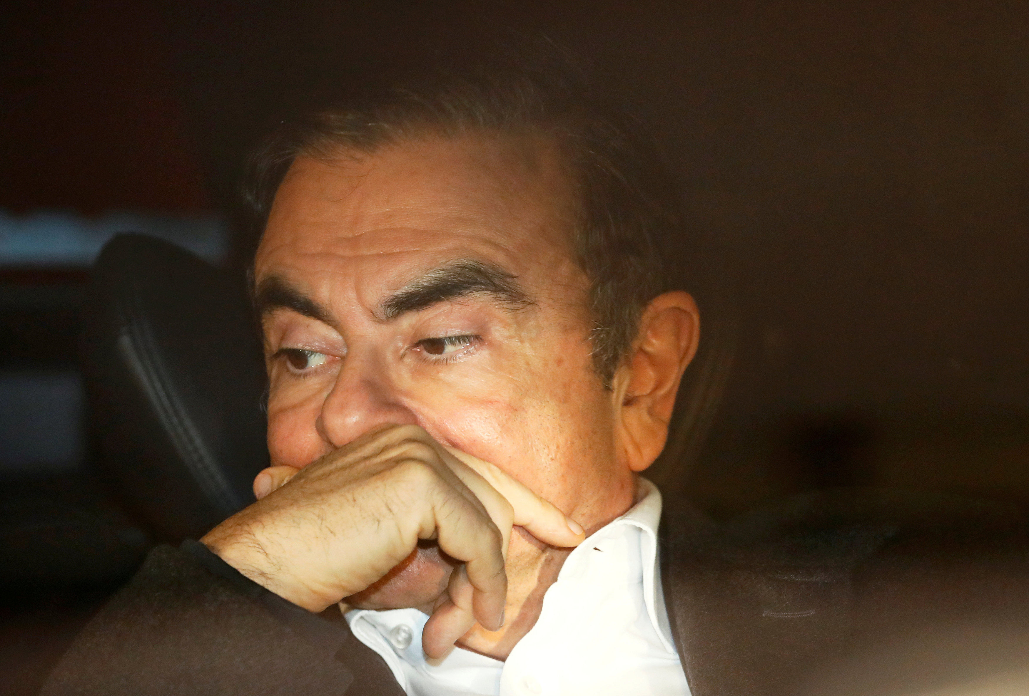 Former Nissan Motor Chairman Carlos Ghosn sits inside a car as he leaves his lawyer's office after being released on bail from Tokyo Detention House, in Tokyo, Japan. (Reuters Photo)
