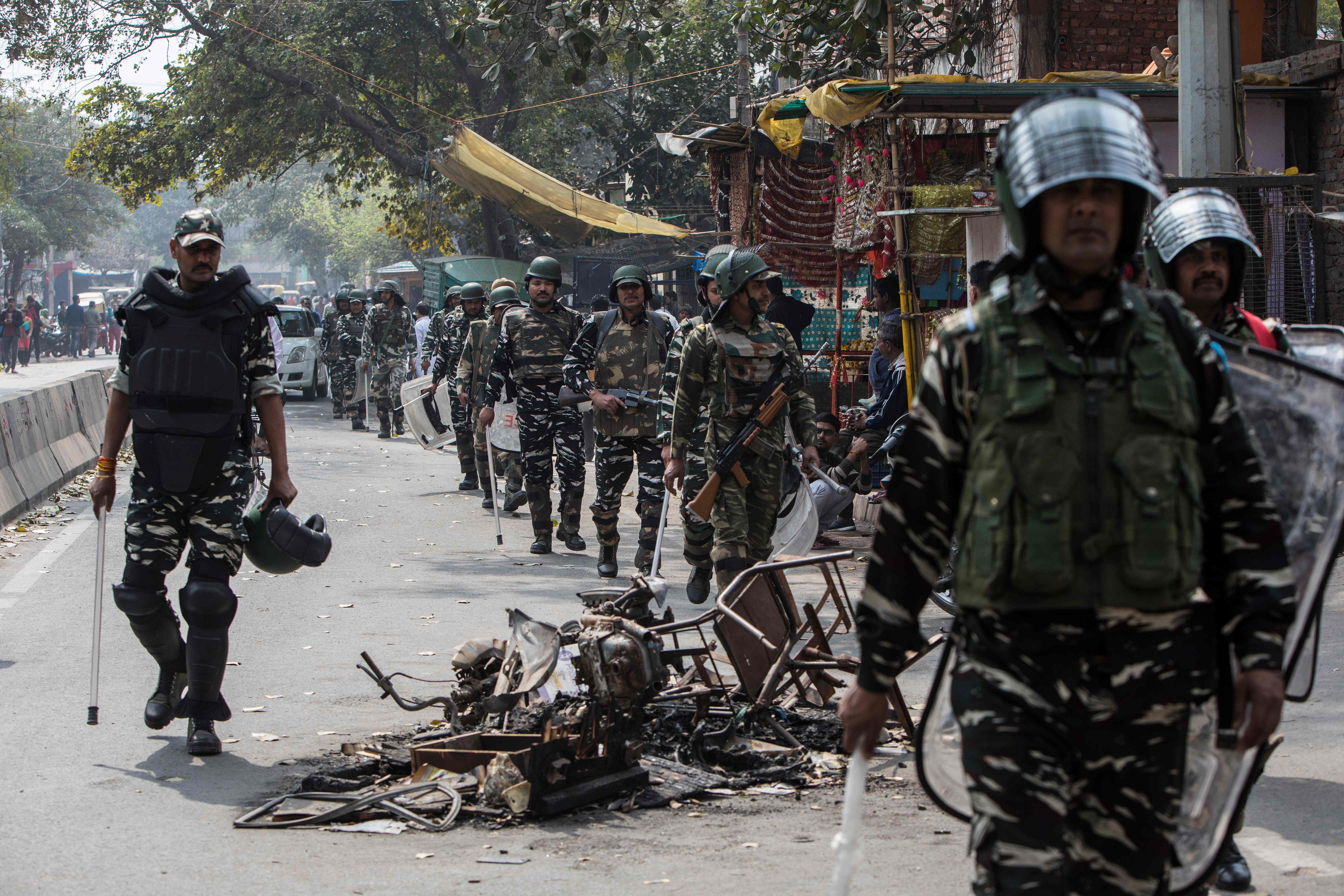 Security personnel patrol along a street following sectarian riots over India's new citizenship law, at Mustafabad area in New Delhi. (AFP Photo)