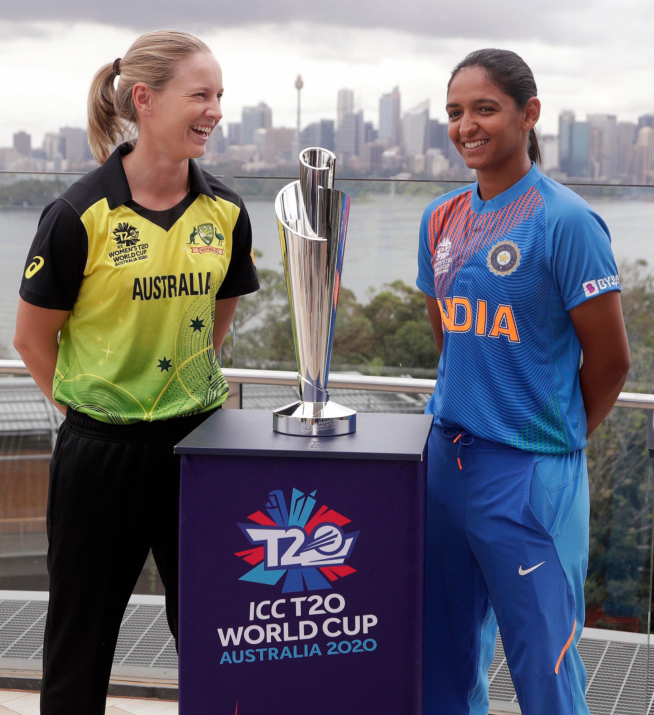 Cricket captains Meg Lanning of Australia, left, and Harmanpreet Kaur of India pose for a photo with the trophy ahead of the Women's T20 World Cup in Sydney. (Credit: AP Photo)