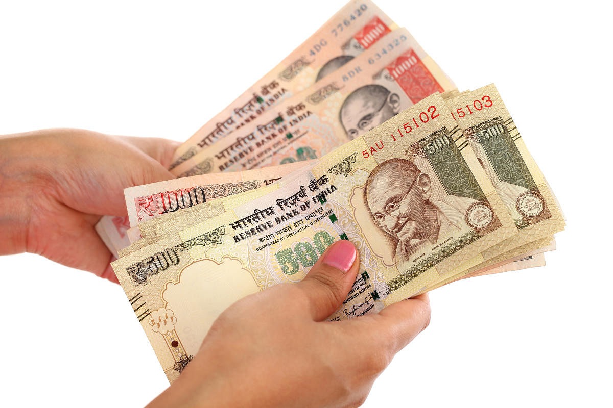 Closeup of woman hands counting money against white background Rupee.