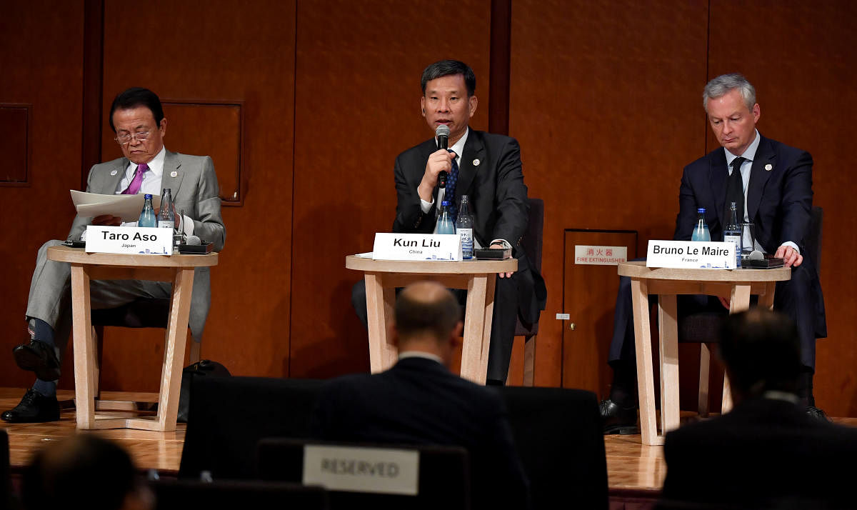 Chinese Finance Minister Liu Kun (C) delivers a speech while Japanese Finance Minister Taro Aso (L) and French Economy and Finance Minister Bruno Le Maire (R) look on during the G20 Ministerial Symposium on International Taxation. (Reuters Photo)