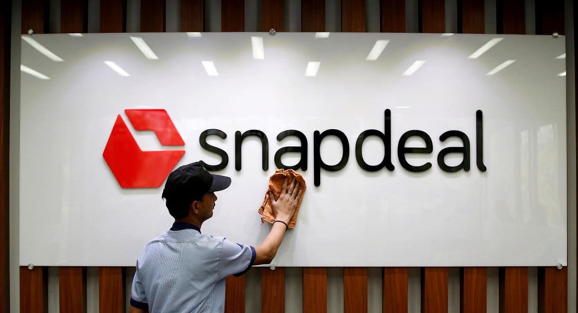 An employee cleans a Snapdeal logo at its headquarters in Gurugram (Reuters File Photo)