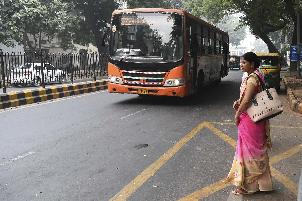 A woman waits to board a Delhi Transport Corporation bus in New Delhi on October 29, 2019. (AFP Photo)