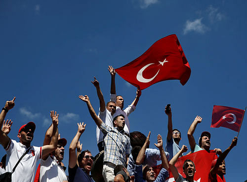 Supporters of Turkish President Tayyip Erdogan shout slogans and wave Turkish national flagsduring a pro-government demonstration in Sarachane park in Istanbul. Reuters photo