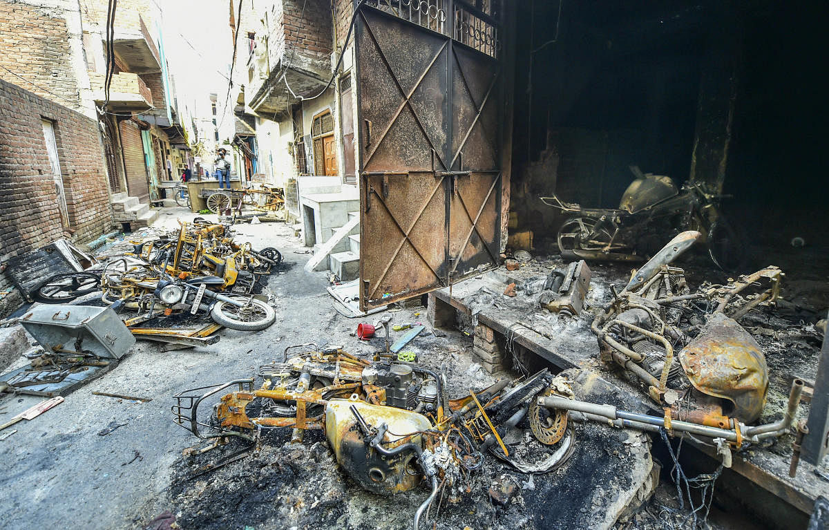 Charred remains of vehicles at Shiv Vihar in riot-affected Northeast Delhi. (PTI Photo)