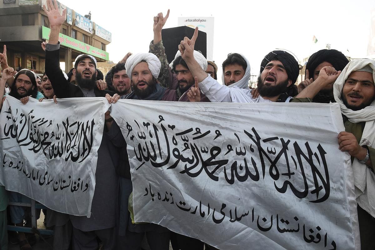 Activists of Jamiat Ulema-e Islam Nazryate party march as they celebrate the signing agreement between the US and the Taliban during a rally in Quetta on March 1, 2020. (AFP Photo)
