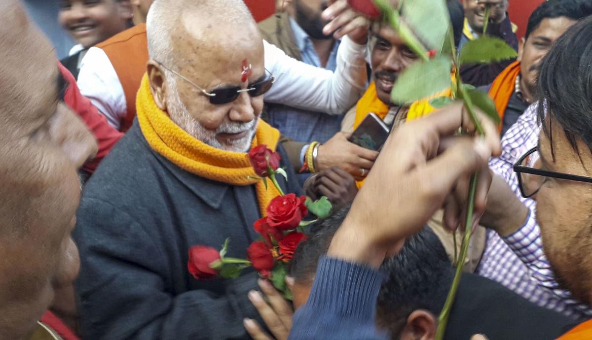 Former union minister Swami Chinmayanand being offered flowers by supporters as he walks out of prison, two days after being granted bail in the case in which he is accused of sexually abusing a law student, at Shahjahanpur, Wednesday, Feb. 5, 2020. (PTI Photo)