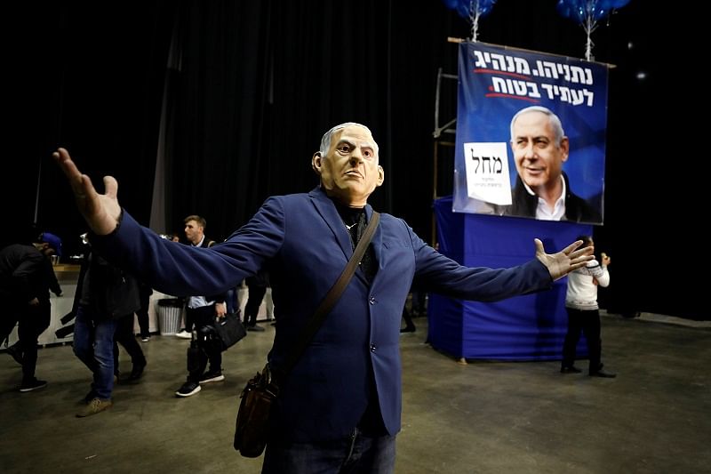 A supporter dressed up as Israeli Prime Minister Benjamin Netanyahu gestures as results of the exit polls in Israel's elections are announced at Netanyahu's Likud party headquarters in Tel Aviv, Israel. (Reuters Photo)
