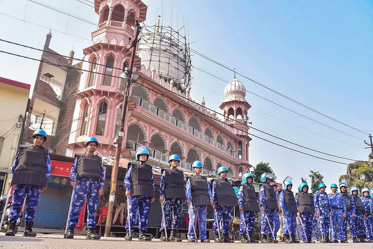 Rapid Action Force (RAF) personnel stand guard during an anti-CAA and NRC protest in Aligarh, Monday, Feb. 24, 2020. (PTI Photo)