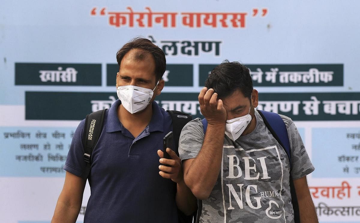 Commuters wear protective masks in wake of the deadly novel coronavirus at a railway station, in Jaipur, March 4, 2020. (PTI Photo)
