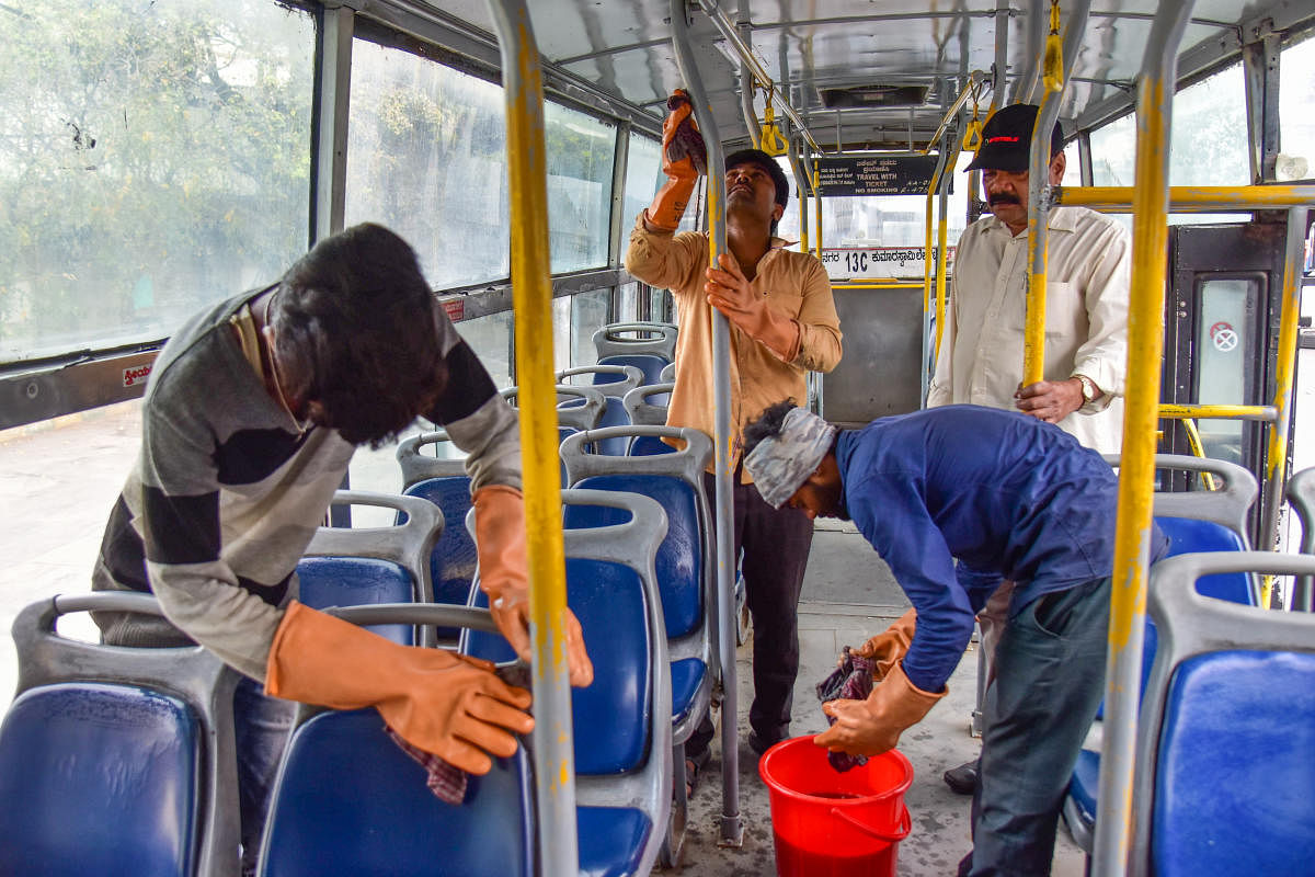 Workers clean a BMTC bus at the BMTC Depot, Shanthi Nagar in Bengaluru on Wednesday. DH Photo/S K Dinesh