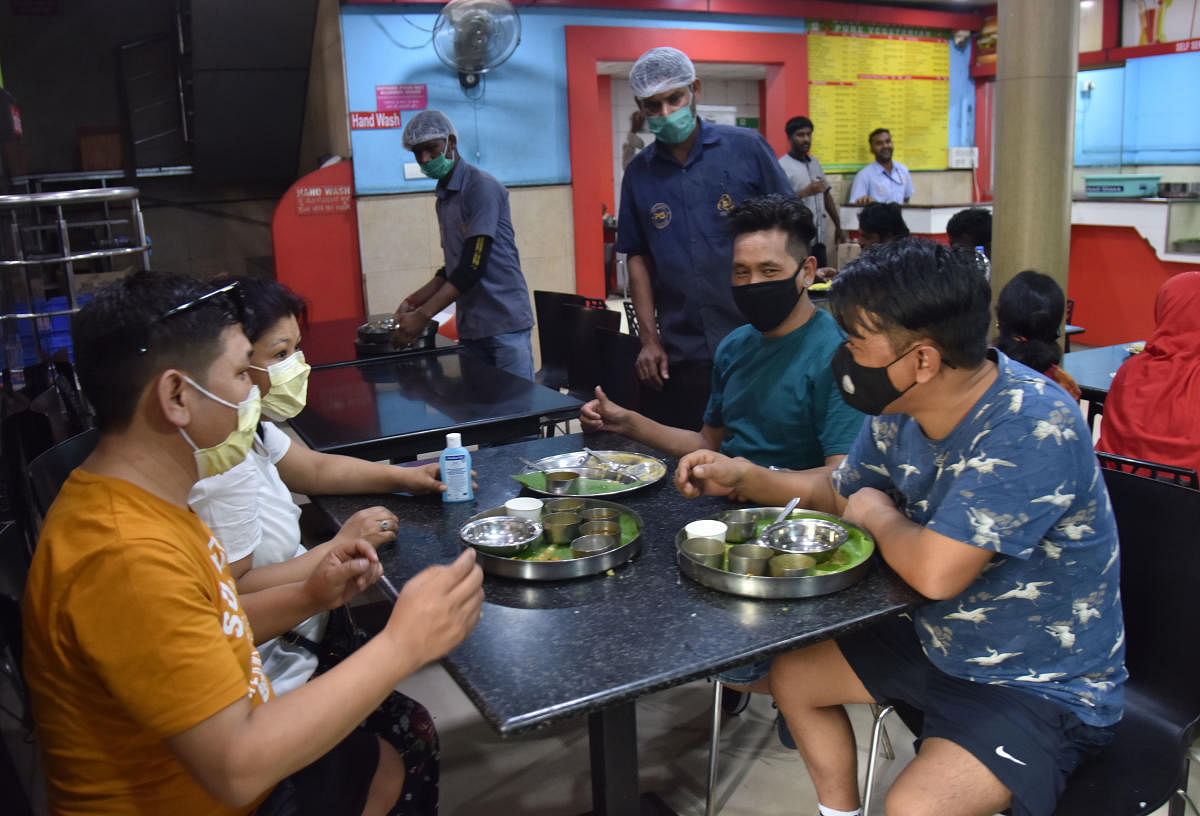 Tourists from Switzerland and hotel staff sport masks at a restaurant at Krantiveera Sangolli Rayanna Railway Station in Bengaluru on March 4, 2020. DH Photo/Janardhan B K