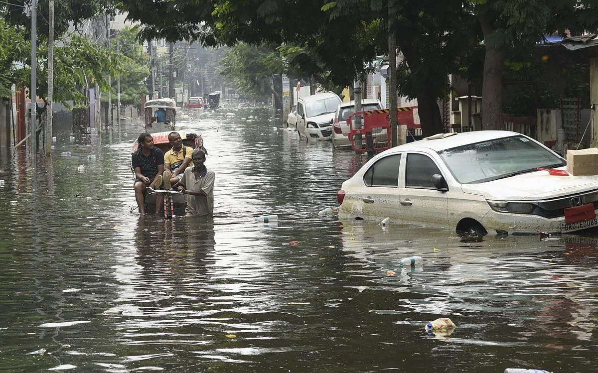 A rickshaw-puller wades through the flood-water in the worst flood-affected Rajendra Nagar area of Patna, Saturday, Oct. 5, 2019. (PTI Photo)