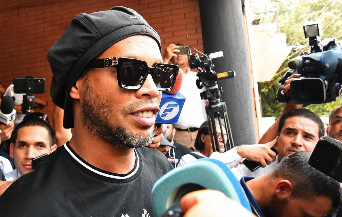 Brazilian retired football player Ronaldinho leaves Asuncion's Prosecution after declaring about his irregular entry to the country. (AFP Photo)