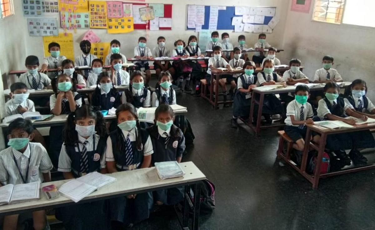 Students attend the class wearing masks at Sandeepani School in Gejjegondanahalli in Ajjampura. Dh Photo