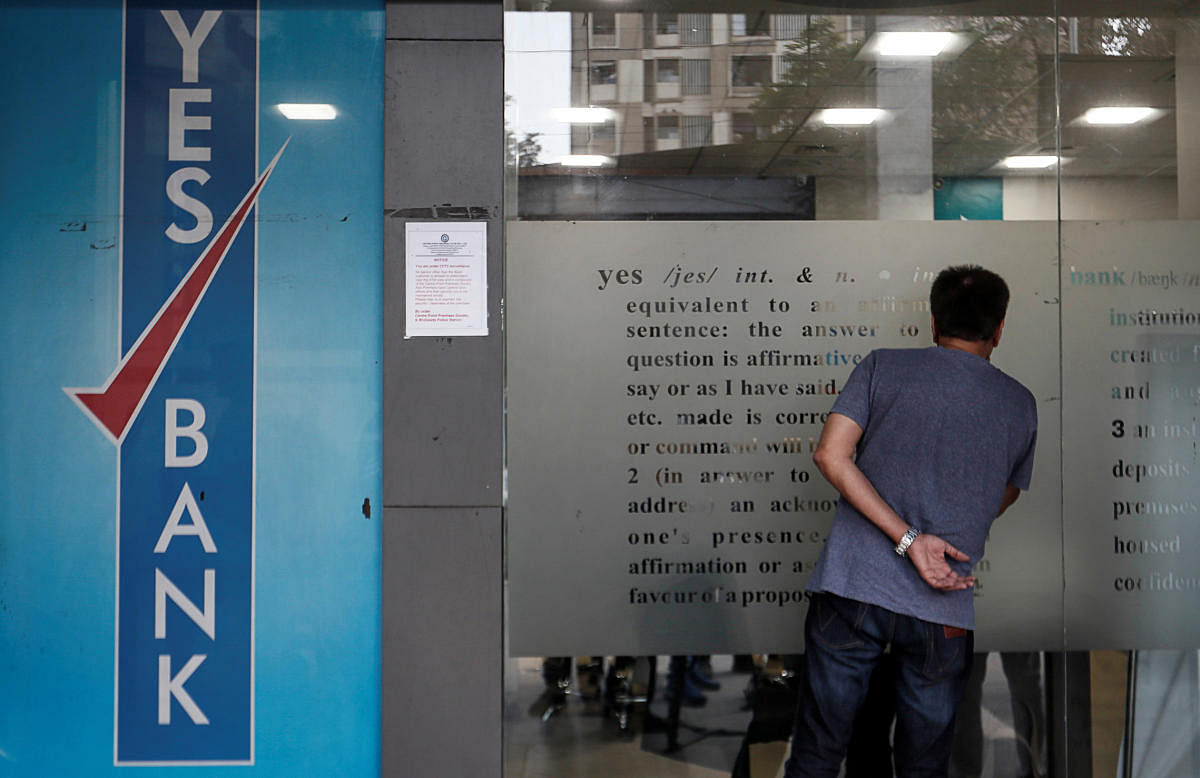 A customer tries to look into a Yes Bank branch in Mumbai. Reuters