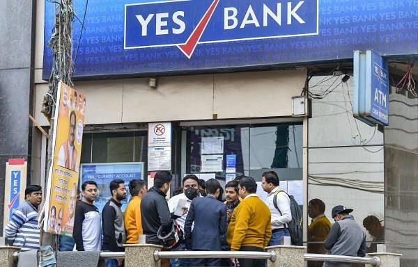Account holders stand in a queue to withdraw money from YES Bank, at Krishna Nagar in New Delhi, Saturday, March 7, 2020. (PTI Photo)