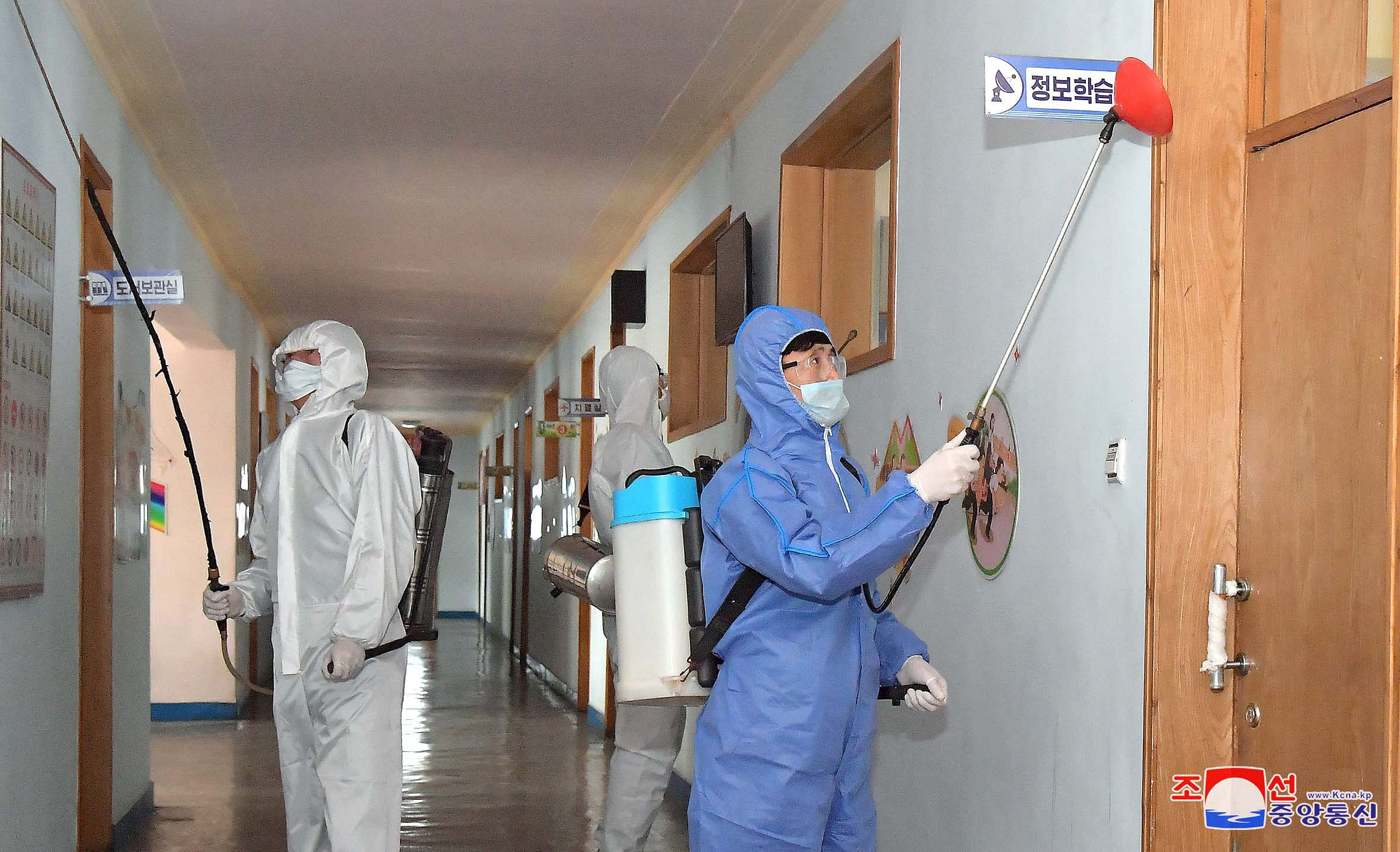 Volunteers carry out disinfection work during an anti-virus campaign in Pyongyang, North Korea. (Credit: Reuters/ KNCA)