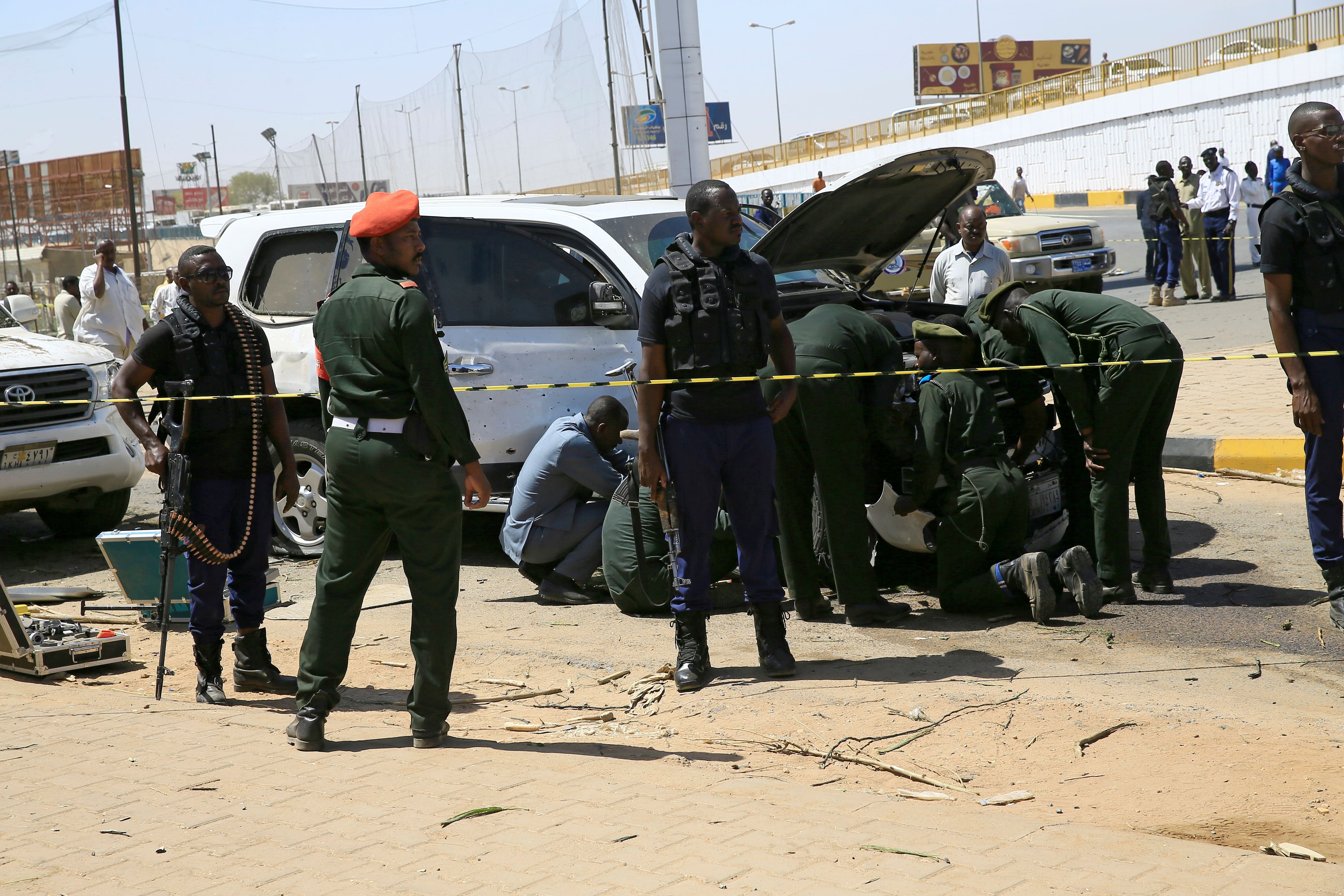 Security personnel stand near a car damaged after an explosion targeting the motorcade of Sudan's Prime Minister Abdallah Hamdok near the Kober Bridge in Khartoum, Sudan. (Credit: Reuters Photo)
