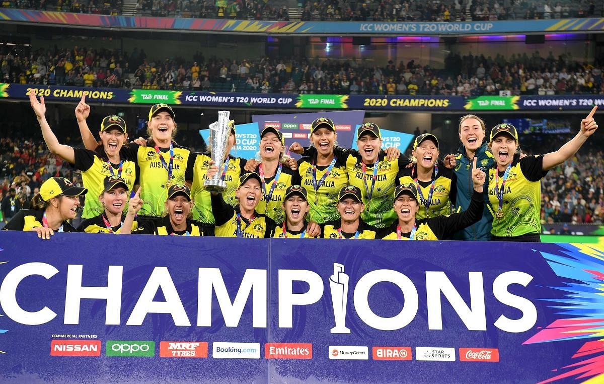 Australia's captain Meg Lanning (C) with teammates celebrate with the winning trophy of Twenty20 women's cricket World Cup after beating India in the final in Melbourne. (AFP Photo)