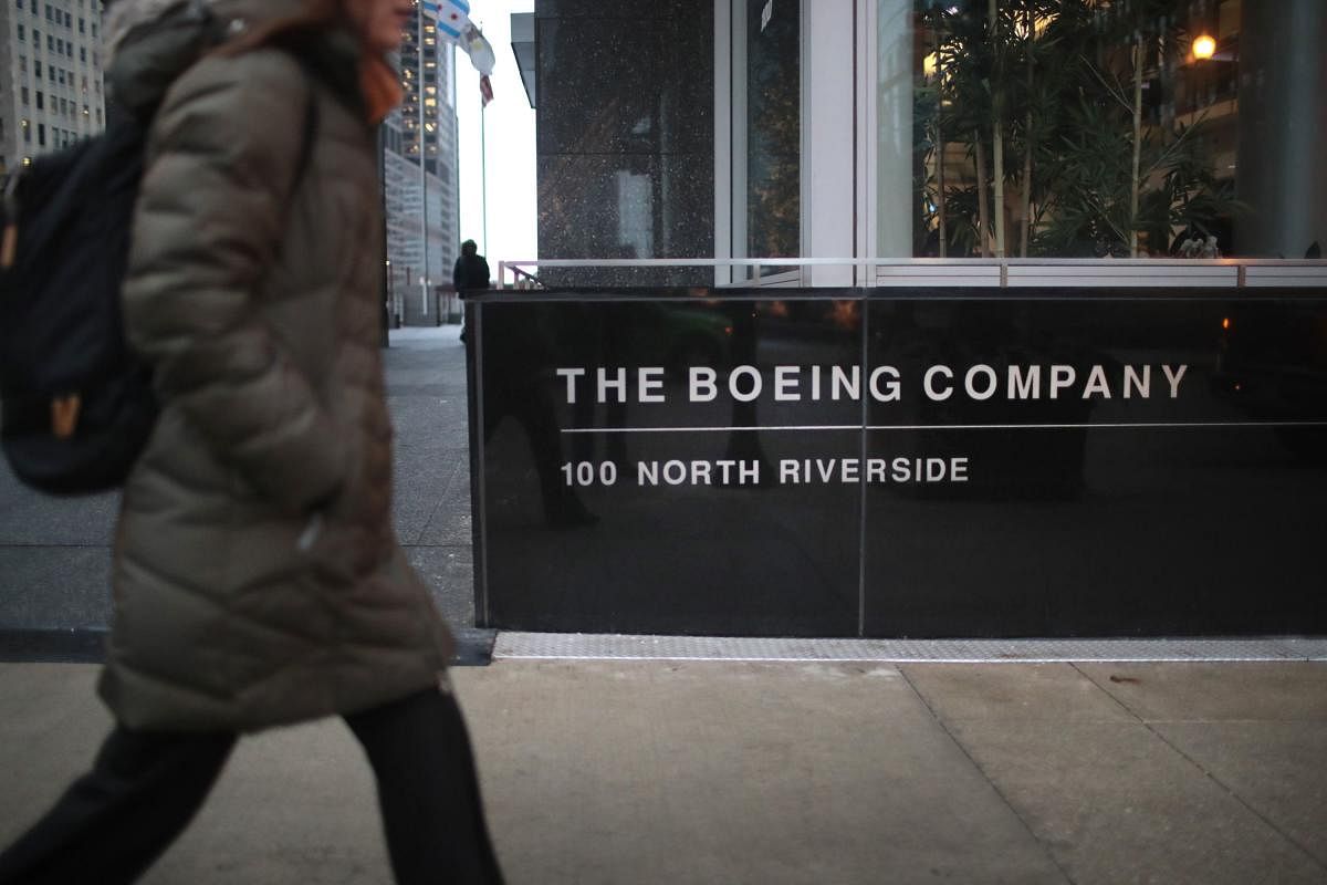  In this file photo a pedestrian walks by the headquarters of The Boeing Company on January 29, 2020 in Chicago, Illinois. Credit: AFP File Photo