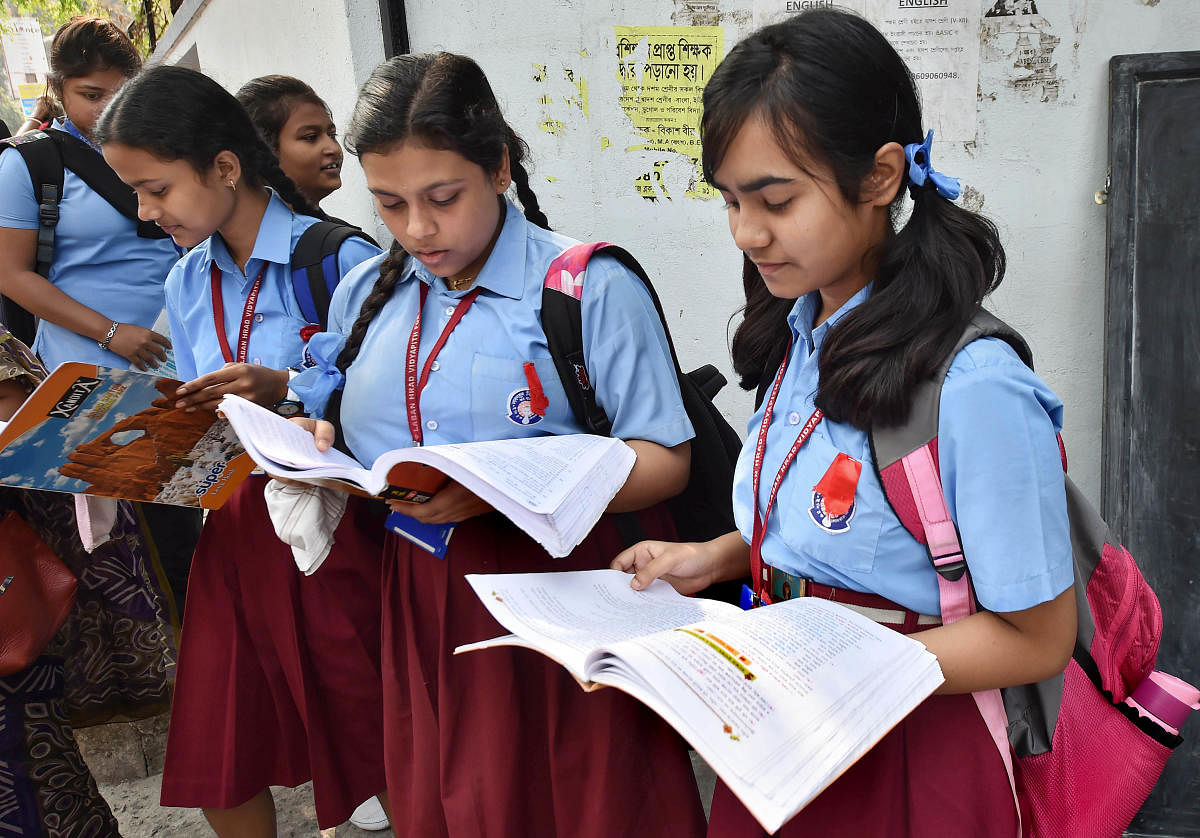 Students revise their syllabus outside an examination centre before appearing for class 10 boards (PTI Photo)