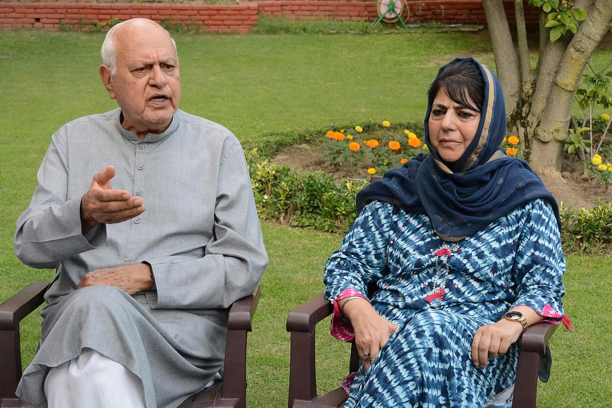 Former Chief Minister of Peoples Democratic Party (PDP) Mehbooba Mufti (R) with Former Chief Minister and Parliament member of National Confrence Farooq Abdullah. Credit: AFP Photo
