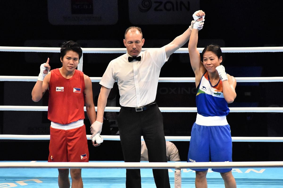 Referee raises the hand of boxer Mary Kom after winning her quarter final bout against Philippines boxer Irish Magno , in the ongoing Asia/Oceania Olympic Qualifiers in Amman, Jordan, Monday, March 9, 2020. (PTI Photo)
