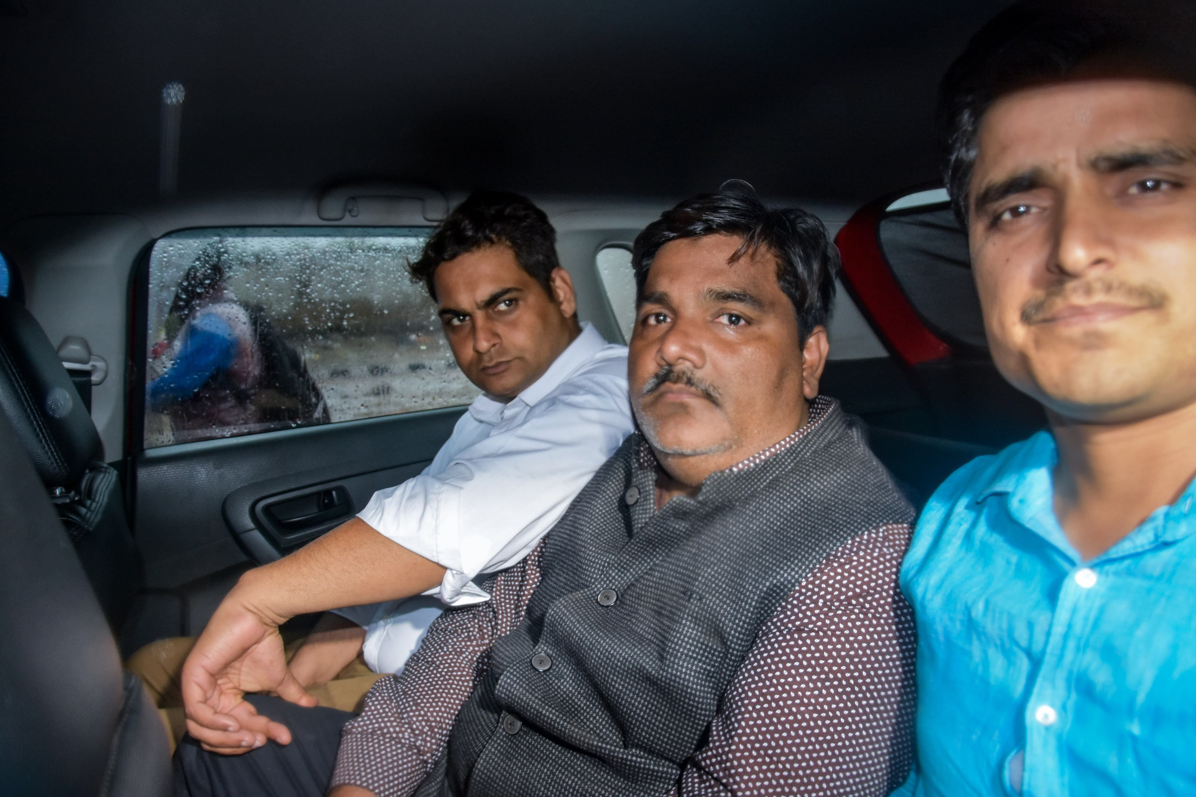 Suspended AAP councillor Tahir Hussain (C) leaves from Sunlight Police Station to produce at Karkardooma Court, in New Delhi. (Credit: PTI file photo)