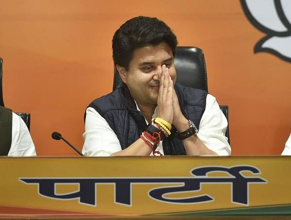 Former Congress leader Jyotiraditya Scindia greets as he joins Bharatiya Janata Party (BJP), at party headquarters in New Delhi, Wednesday, March 11 , 2020. (PTI Photo/Arun Sharma)