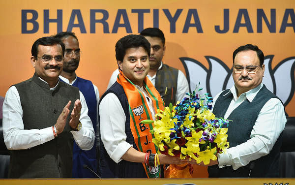 Former Congress leader Jyotiraditya Scindia (C) is welcomed as he joins Bharatiya Janata Party (BJP) in presence of BJP President JP Nadda (R), at BJP headquarters in New Delhi, Wednesday, March 11 , 2020. Also seen is BJP Madhya Pradesh state president Vishnu Dutt Sharma (L). (PTI Photo/Arun Sharma) 