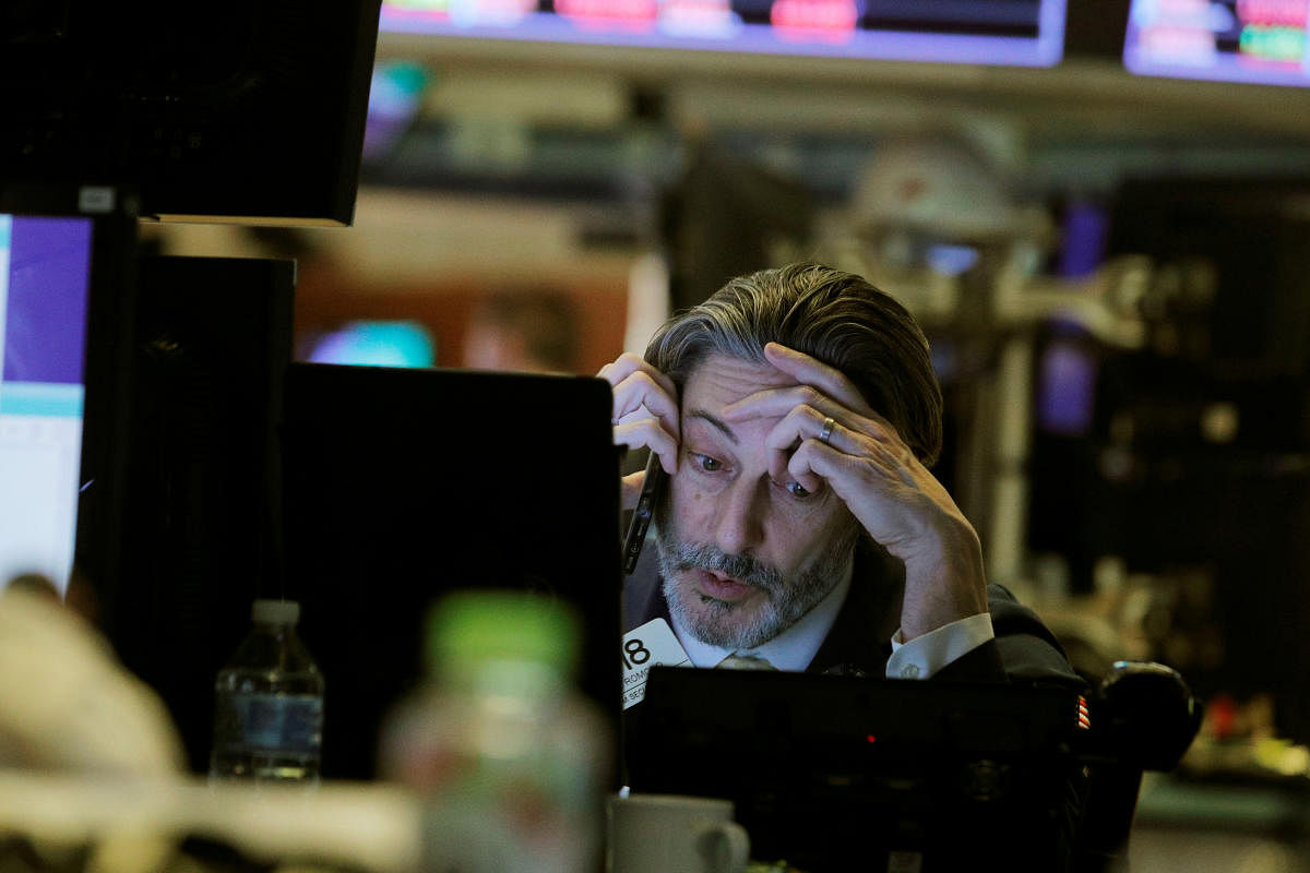 A trader talks on the phone while working on the floor of the New York Stock Exchange (NYSE) in New York. Reuters