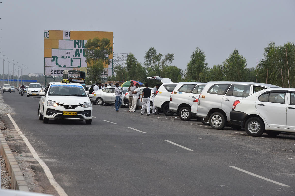 Taxis seen at Beguru road near Kempegowda International Airport new alternative road in Bengaluru. (DH Photo by S K Dinesh)