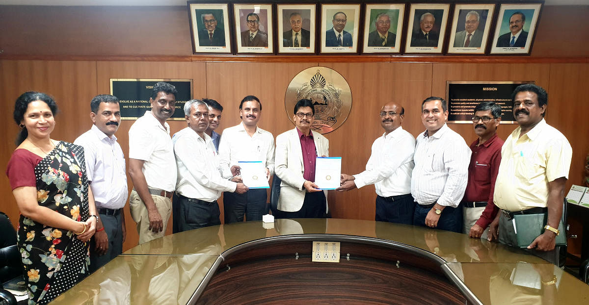 Mangalore University (MU) Vice Chancellor Prof P S Yadapadithaya and Registrar (Evaluation) Prof A M Khan receive copies of Vision Document from members of Mangala Alumni Association in VC's office in Mangalore University campus on Wednesday.